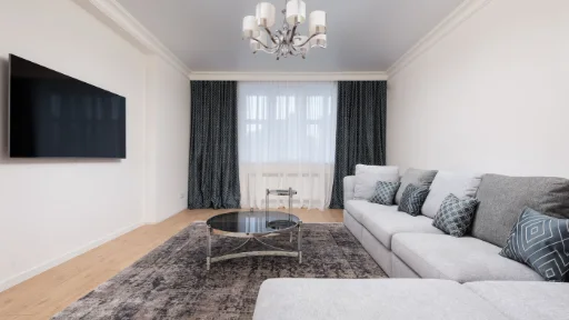 A television with a dark screen in a furnished living room